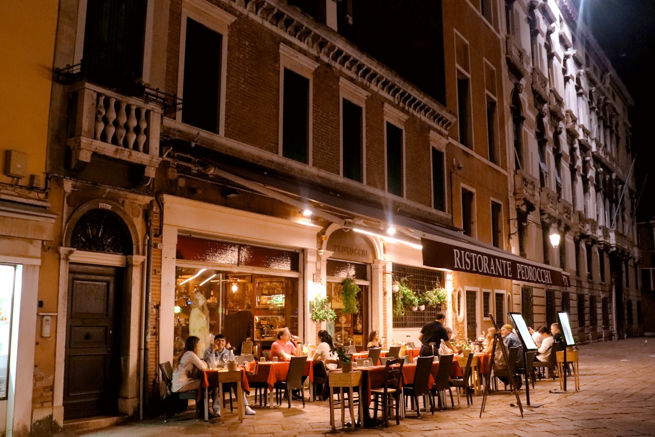 Mastering the First Impression: Your intriguing post title goes here Charming evening ambiance of diners enjoying a meal at Ristorante Pedrocchi in Venice, Italy.